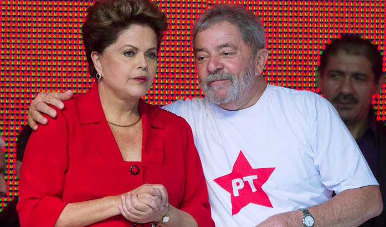 Brazil's President Dilma Rousseff (L) stands with her predecessor Luiz Inacio Lula da Silva at the national convention of their Workers' Party (PT) in Brasilia June 21, 2014. The party confirmed at the convention that Rousseff will be the candidate for re