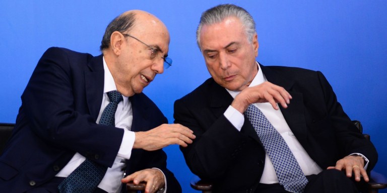 Brazilian Finance Minister Henrique Meirelles (L) and acting President Michel Temer attend a meeting