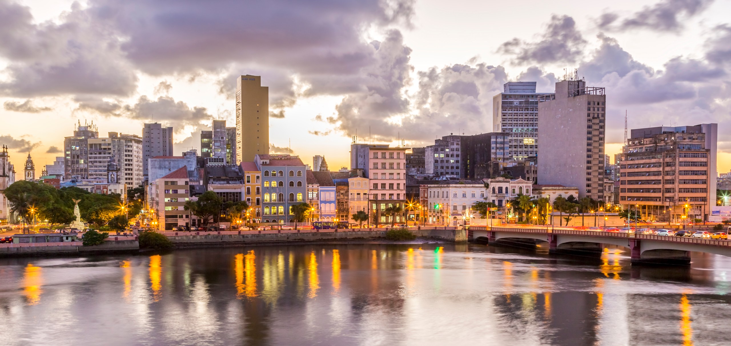 Skyline of Recife in Pernambuco, Brazil showcasing its historic architecture at sunset by the Capibaribe River.