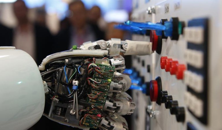 The hand of humanoid robot AILA (artificial intelligence lightweight android) operates a switchboard during a demonstration by the German research centre for artificial intelligence at the CeBit computer fair in Hanover March, 5, 2013. The biggest fair of its kind open its doors to the public on March 5 and will run till March 9, 2013. REUTERS/Fabrizio Bensch (GERMANY - Tags: POLITICS) - RTR3ELOG