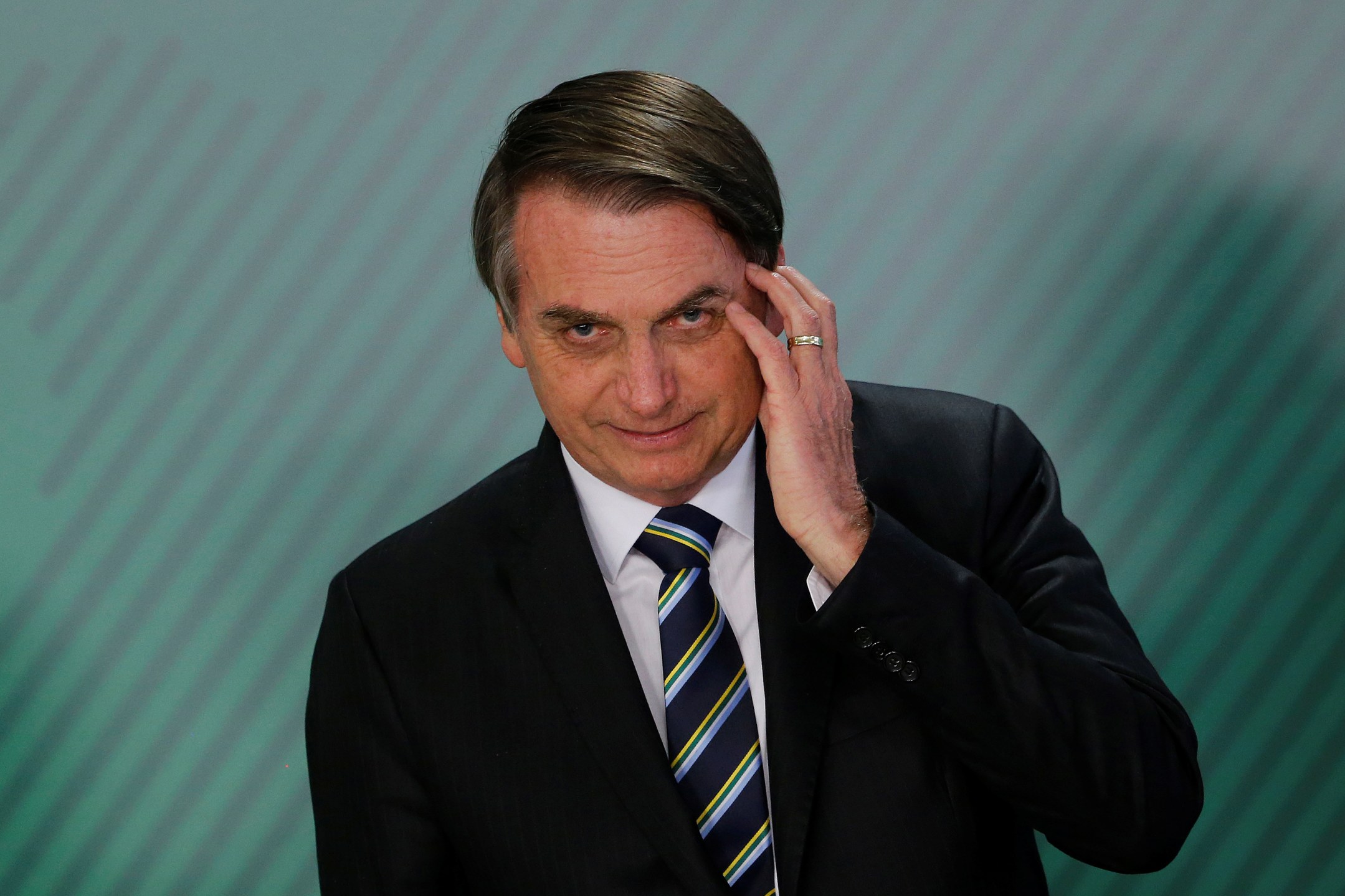 Brazil's President Jair Bolsonaro gestures during inauguration ceremony of the new Education Minister Abraham Weintraub at the Planalto Palace in Brasilia, Brazil April 9, 2019. REUTERS/Adriano Machado