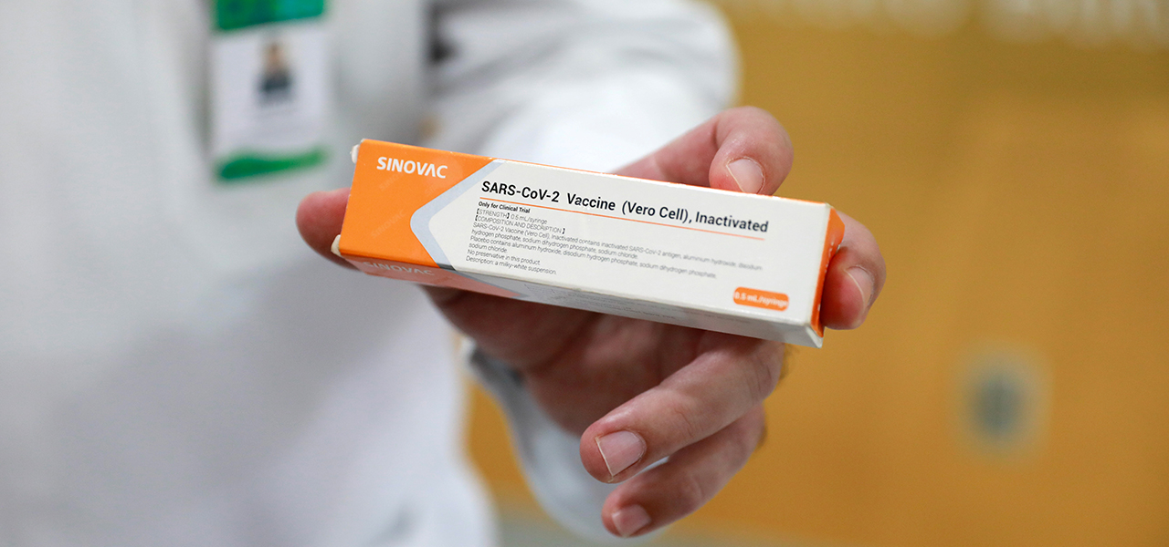 Profissional de saúde segura caixa de potencial vacina contra Covid-19 da chinesa Sinovac durante testes em Porto Alegre
