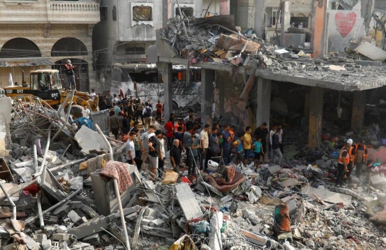 Palestinians look on during a search for casualties at the site of Israeli strikes on houses, in Khan Younis, in the southern Gaza Strip, October 25, 2023. REUTERS/Ibraheem Abu Mustafa