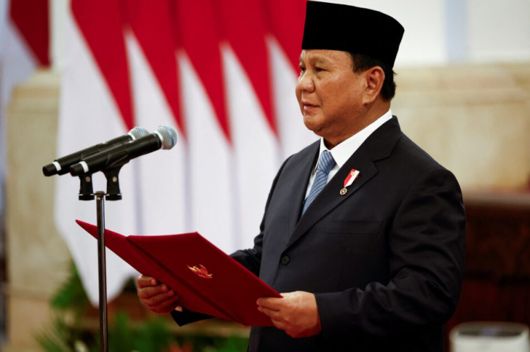 O presidente indonésio, Prabowo Subianto, lê os votos feitos pelos ministros recém-nomeados durante a posse no palácio presidencial em Jacarta, em 21 de outubro de 2024