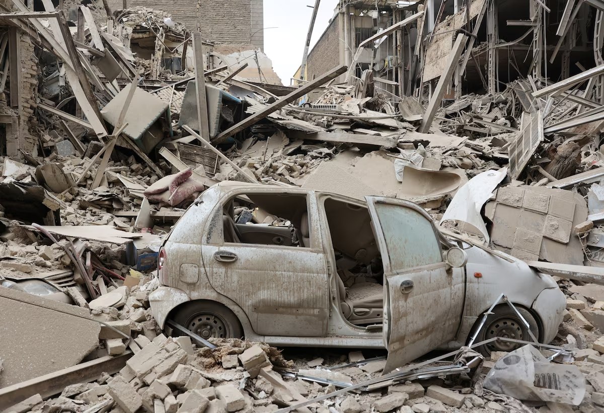 Um veículo destruído entre os escombros no local de um ataque a um prédio residencial, em meio ao conflito entre EUA e Israel com o Irã, em Teerã, Irã, 16 de março de 2026