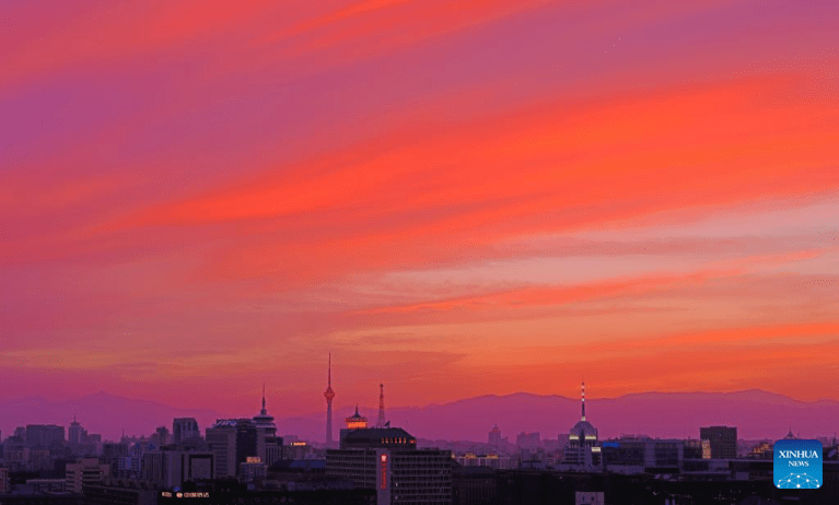 Céu de Beijing ganha tons alaranjados e dourados com nuvens marcantes ao pôr do sol